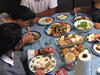 An Iraqi family sitting down for a meal 296