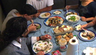 An Iraqi family sitting down for a meal 296