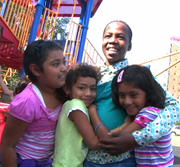 Girls on a playground hugging - welcome video