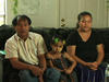 Family from Burma on couch at home