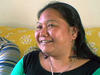 Woman from Burma on her couch at home