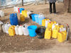 Water storage in camp where Darfuris live in Chad